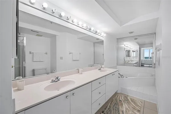 a bathroom with a shower sink double and mirror