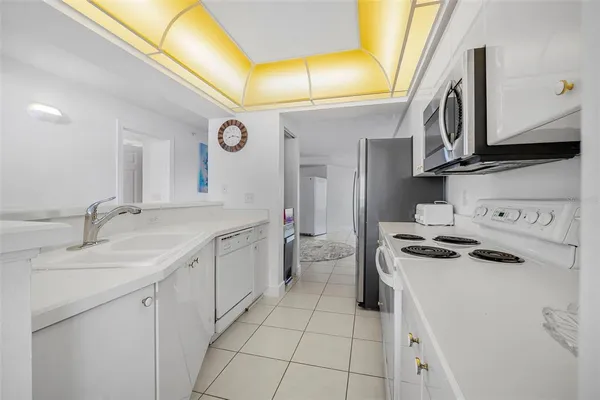 a spacious bathroom with a granite countertop sink and a mirror