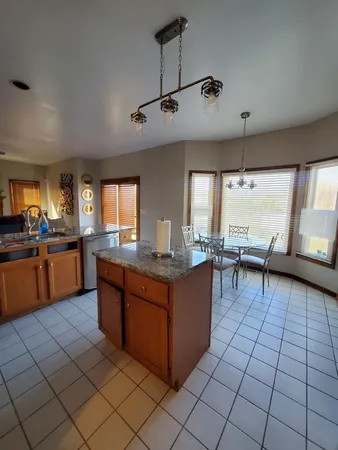 a kitchen with stainless steel appliances granite countertop a sink counter space cabinets and a window