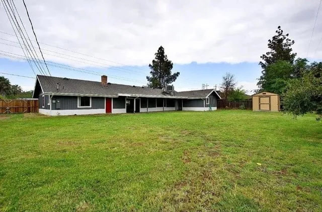 a bathroom with a granite countertop sink and a large mirror