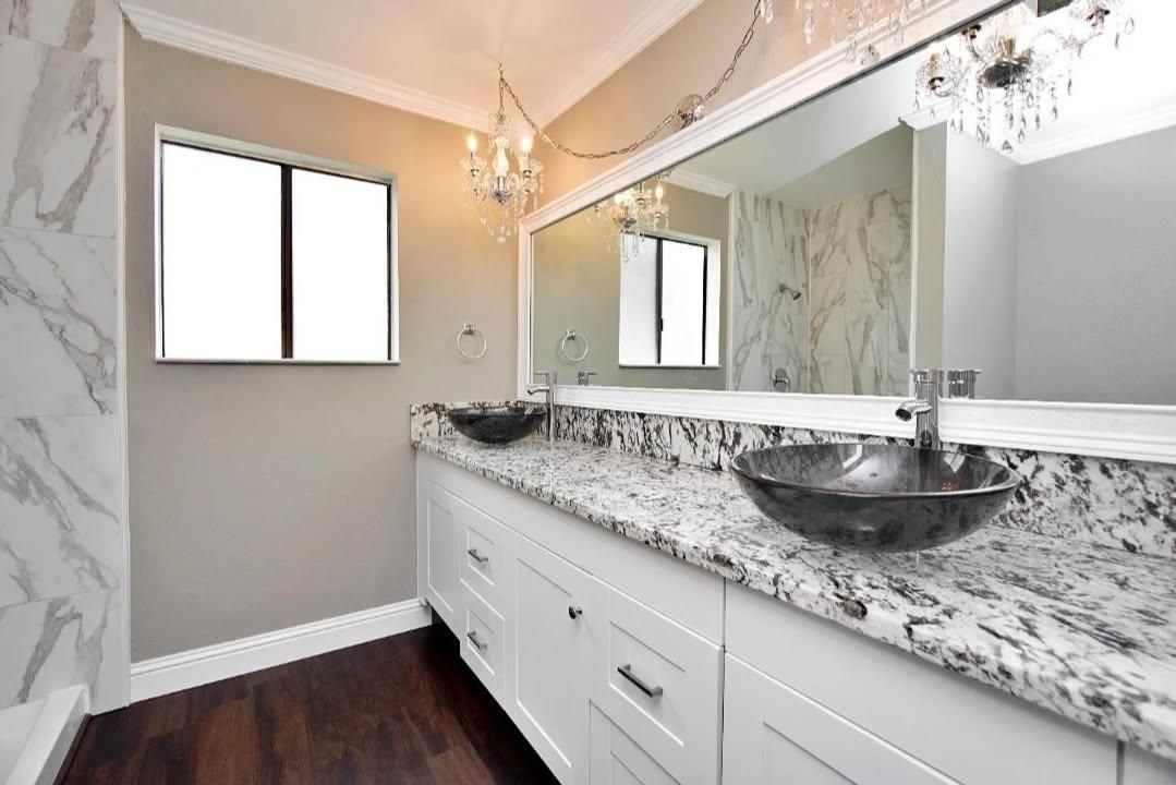 36620 Ave 12 Madera, CA 93636 - Photo 7 of 12 a bathroom with a granite countertop sink and a large mirror