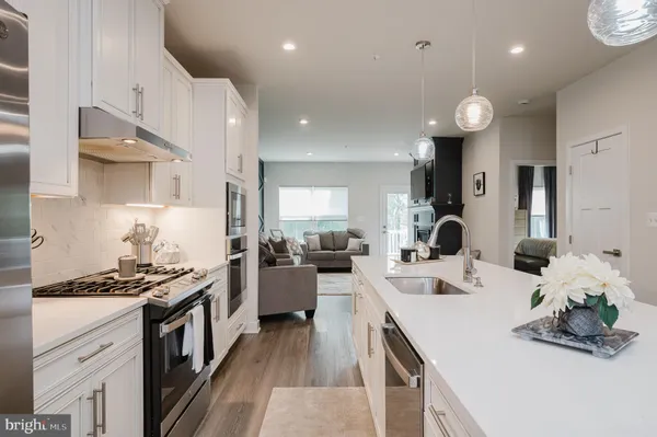 a kitchen with counter top space a sink stainless steel appliances and cabinets