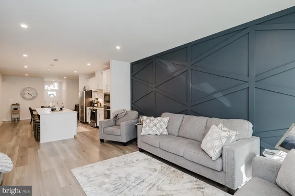 a living room with furniture and kitchen view