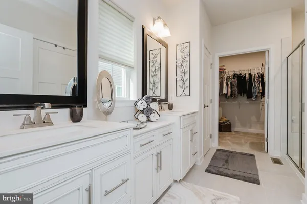 a bathroom with a double vanity sink and a mirror