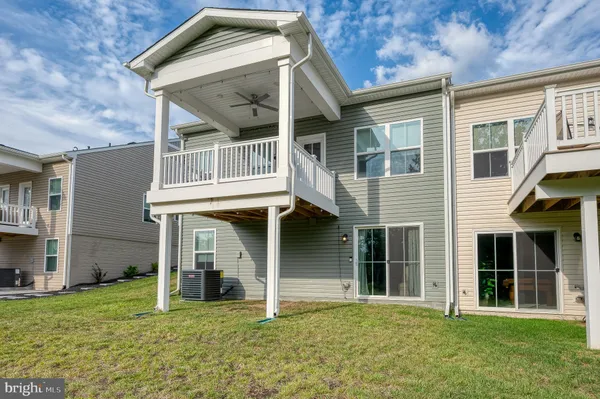 a view of a grassy field with trees in the background