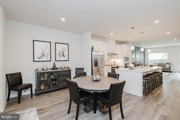 a large kitchen with a table and chairs