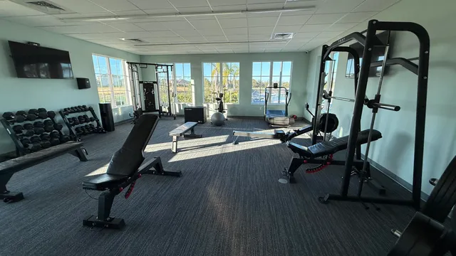 a living room with furniture gym equipment and a flat screen tv