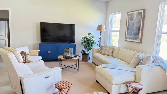 a living room with furniture and a flat screen tv