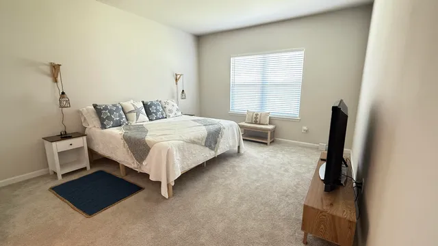 a bed room with a bed and a chair