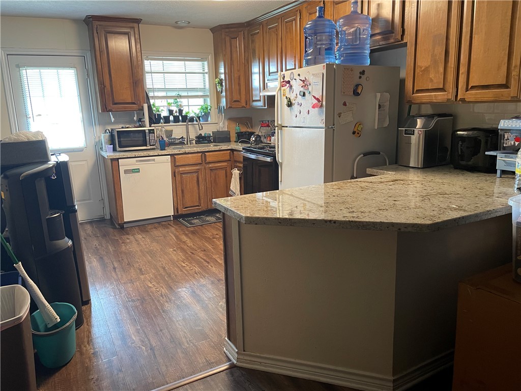 902 Azalea Court College Station, TX 77840 - Photo 5 of 10 Kitchen with white appliances, a sink, dark wood-s
