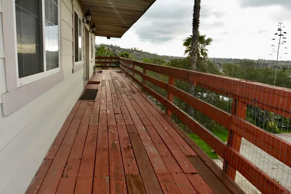 a view of a porch with wooden floor