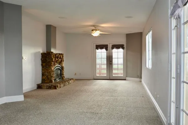 a view of an empty room with windows