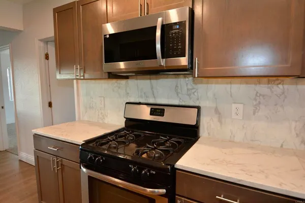 a kitchen with a stove and a microwave