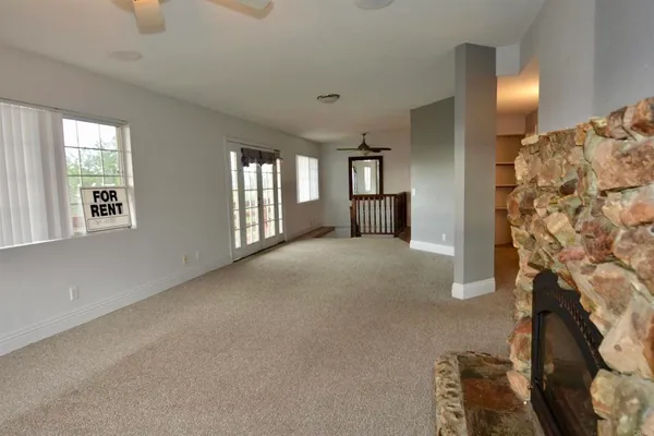 a view of an empty room with a fireplace