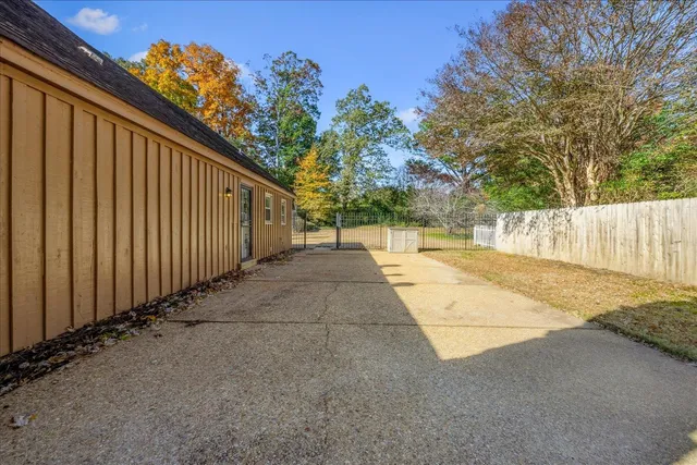a view of a street with wooden fence