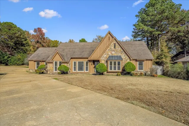 a front view of a house with a garden