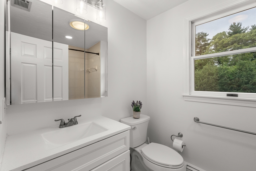322 Concord Road Wayland, MA 01778 - Photo 25 of 35 a bathroom with a sink a toilet and a window