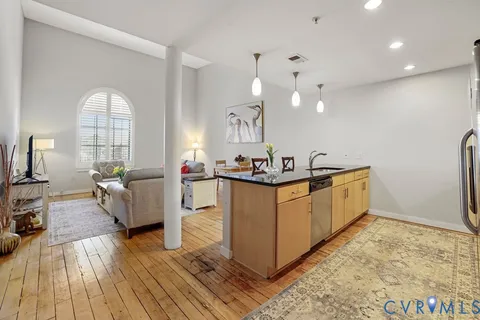 a view of a kitchen with a sink and refrigerator