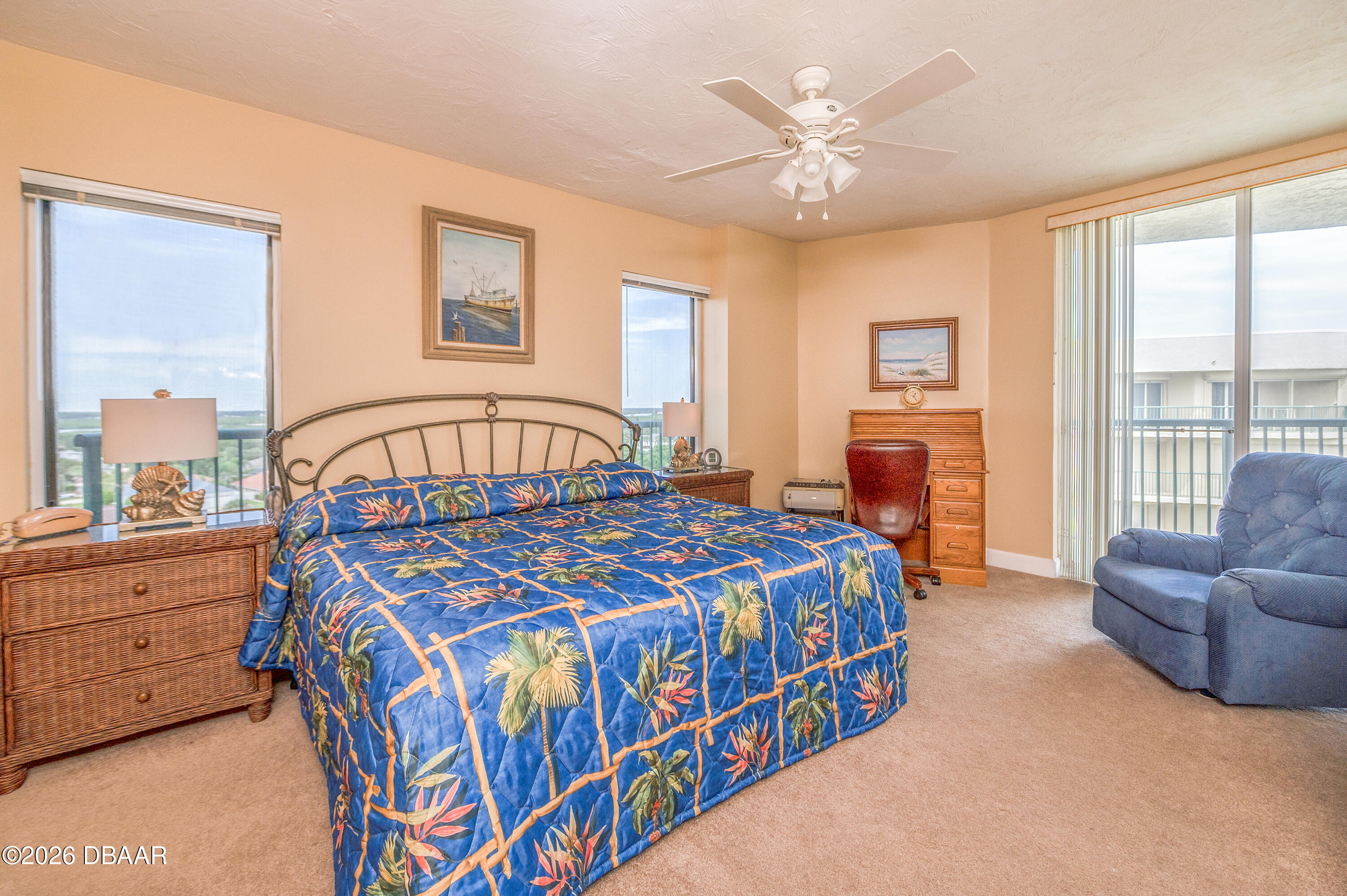 4575 South Atlantic Avenue, Unit 6701 Ponce Inlet, FL 32127 - Photo 16 of 35 a bedroom with a bed a couch and a large window with the outer view