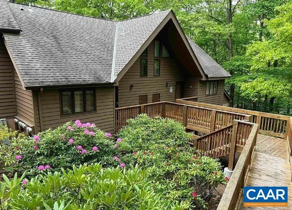 a view of a house with wooden fence