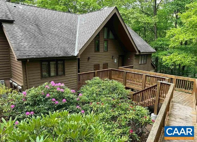 a view of a house with wooden fence