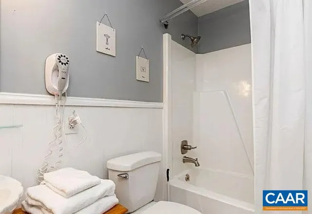 a white toilet sitting next to a bath tub shower
