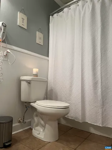 a white toilet sitting next to a small bathroom