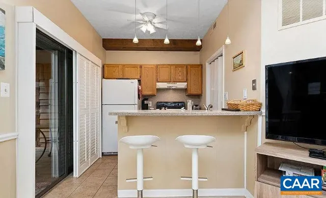 a kitchen with stainless steel appliances granite countertop a refrigerator a sink and a stove