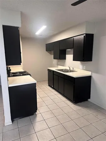 a kitchen with a cabinets and white appliances