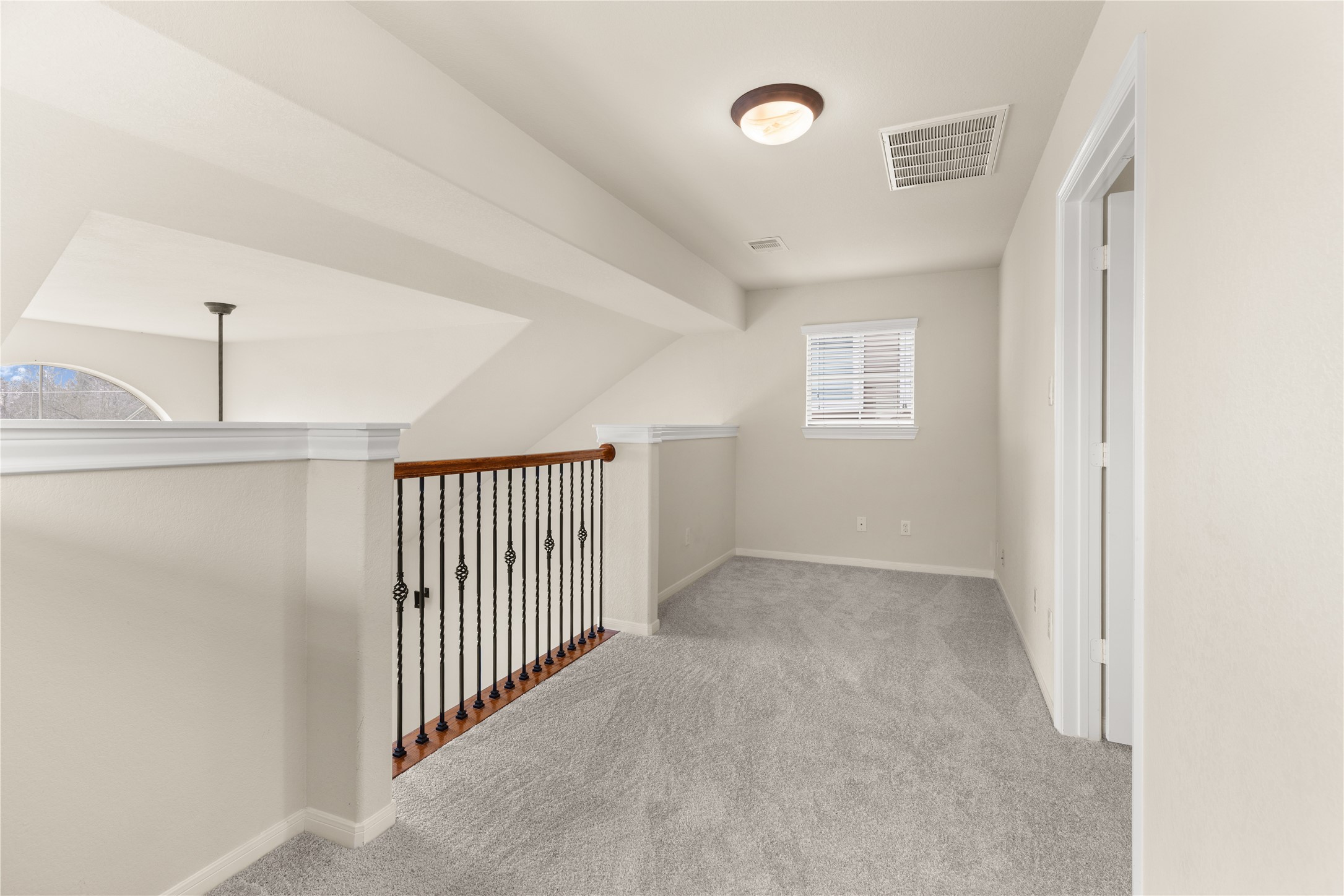 3334 Clearview Villa Way Houston, TX 77025 - Photo 12 of 35 This photo depicts the third floor master suite... Including a carpeted upstairs landing area with a railing overlooking the lower floor. It is a cozy sitting area or extra work space