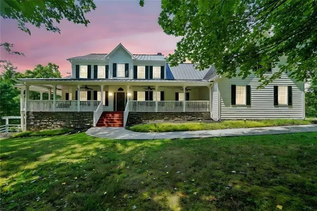 a view of a house with backyard sitting area and swimming pool
