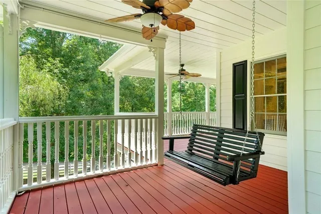 a living room with stainless steel appliances furniture a fireplace and a kitchen view