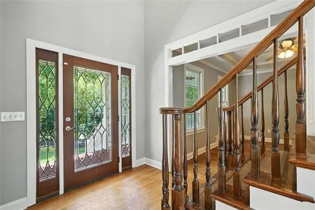 a kitchen with stainless steel appliances granite countertop a stove a sink dishwasher and a refrigerator with wooden floor