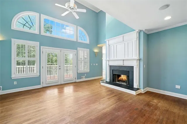 a view of an empty room with chandelier fan