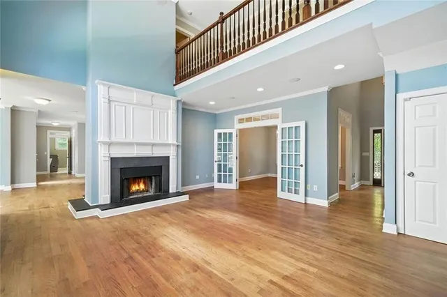an empty room with window and ceiling fan