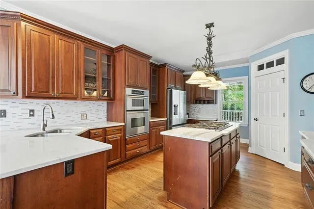 a bathroom with a sink a large mirror and a bathtub next to a window