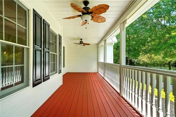 a view of a room with wooden floor chandelier and windows