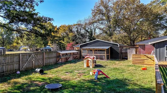 a view of a chair and table in backyard of the house