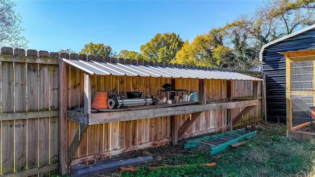 a view of a house with backyard and wooden fence