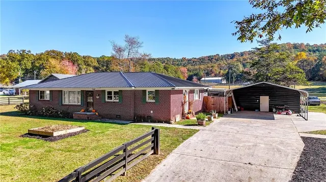 a view of a house with swimming pool and a yard
