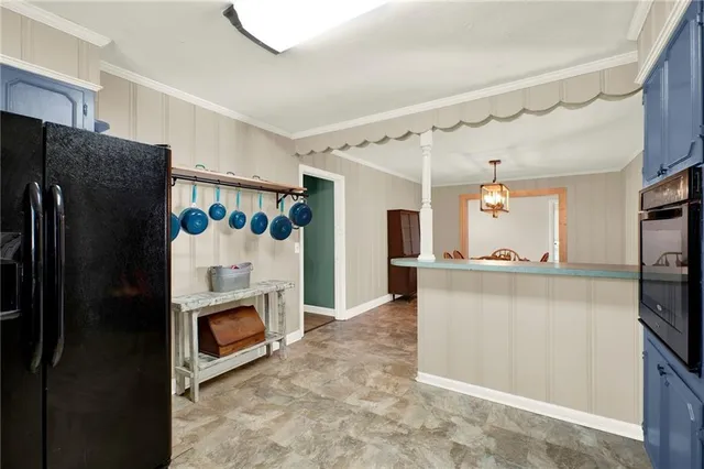 a view of a dining room with furniture and a chandelier