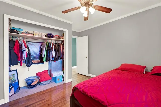 a living room with hard wood floors and a ceiling fan