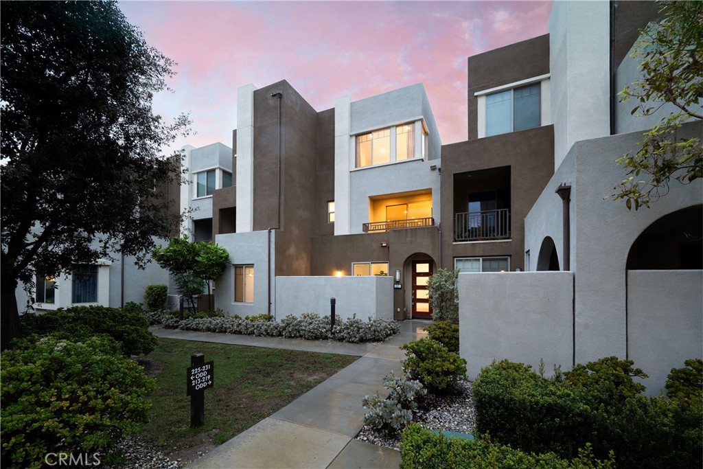 a front view of a house with swimming pool and sitting area