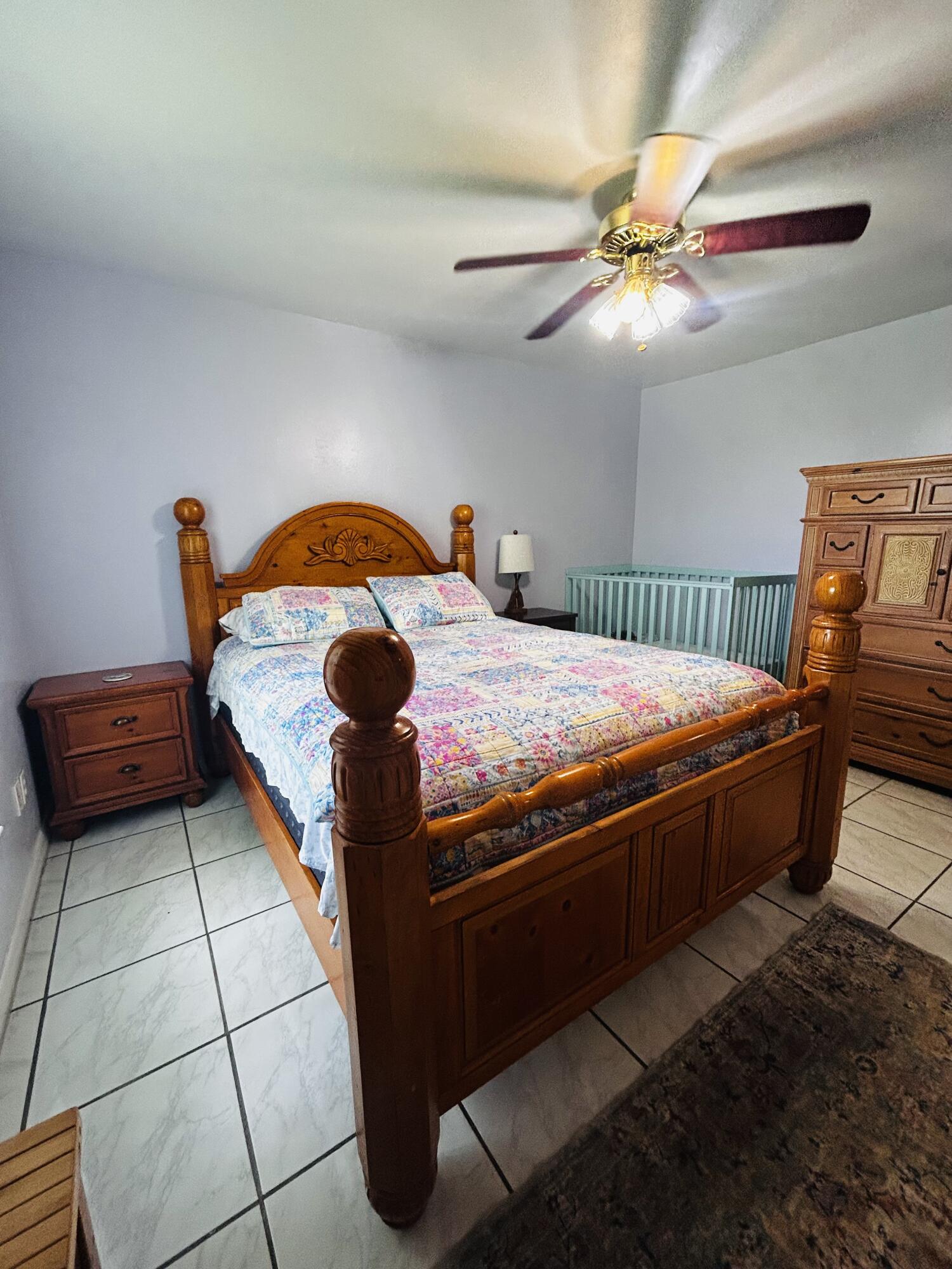 340 Pine Lane Clewiston, FL 33440 - Photo 20 of 46 a bedroom with a bed and a ceiling fan