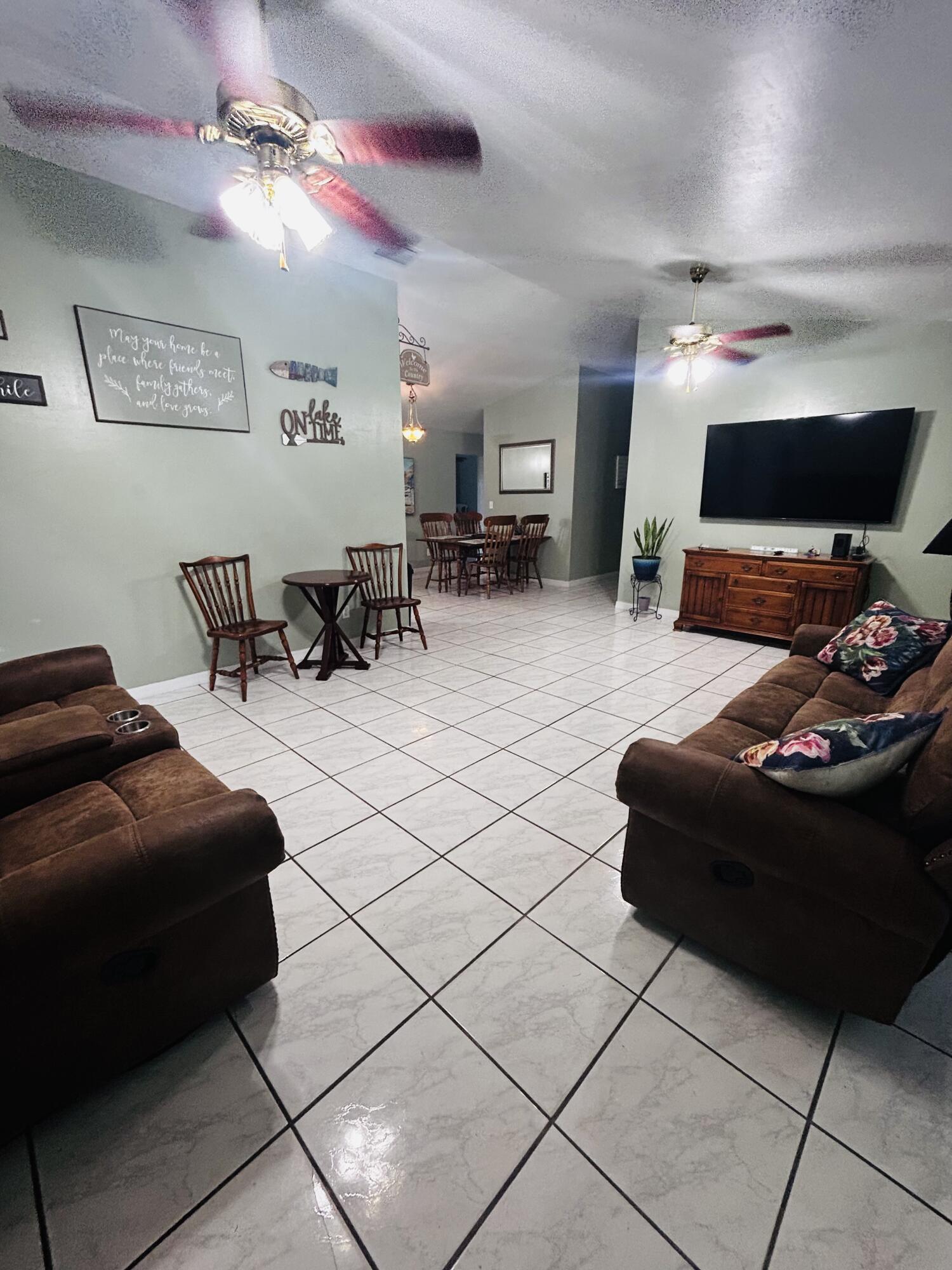 340 Pine Lane Clewiston, FL 33440 - Photo 8 of 46 a living room with furniture and a fireplace