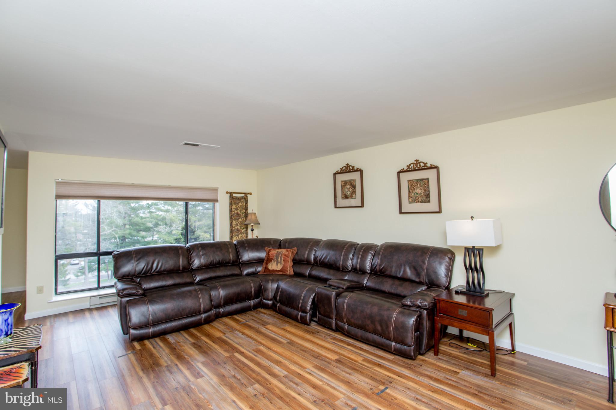 1680 Huntingdon Pike, Unit CONDO 224 Huntingdon Valley, PA 19006 - Photo 12 of 50 a living room with a couch wooden floor and a window