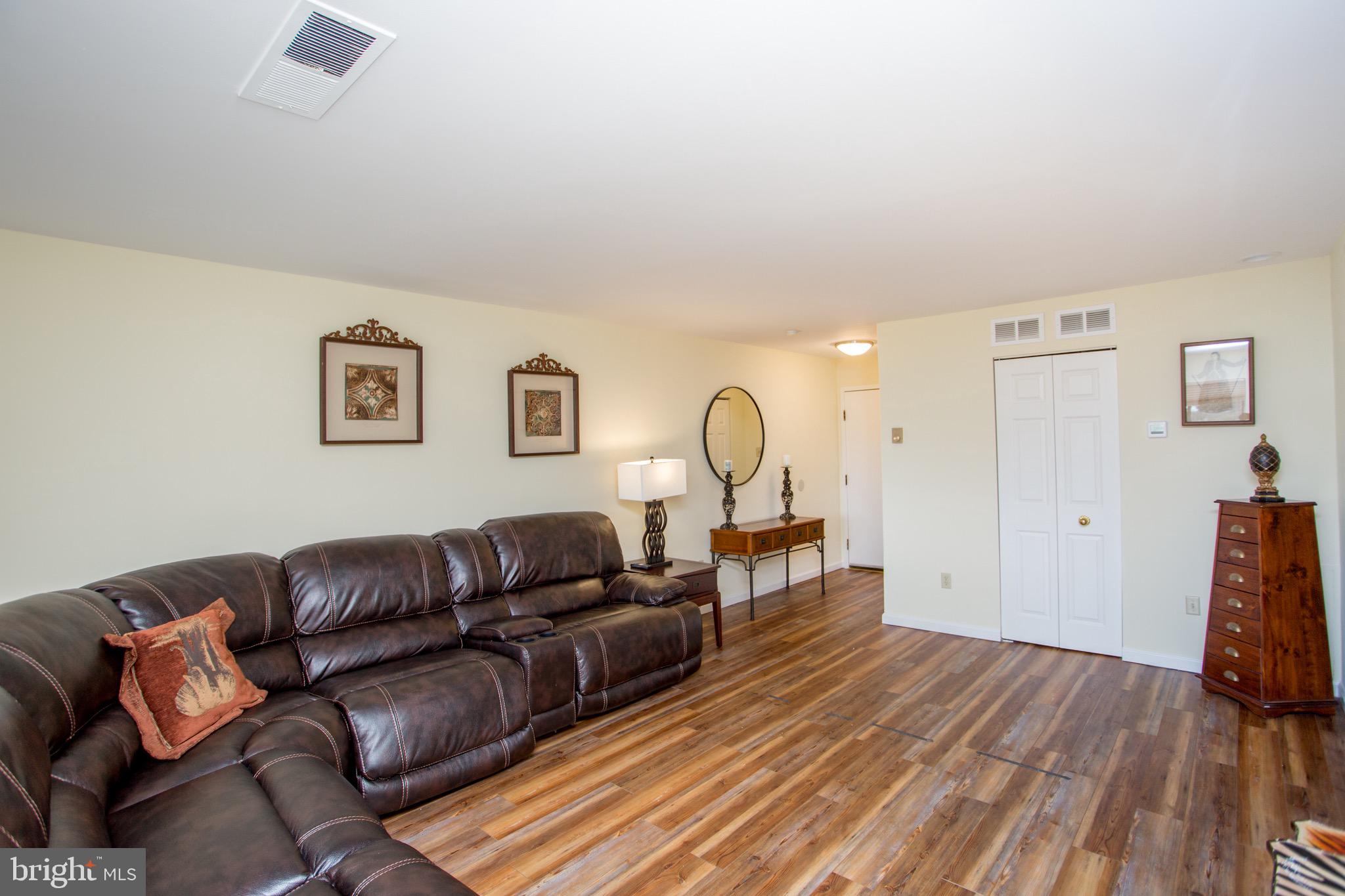 1680 Huntingdon Pike, Unit CONDO 224 Huntingdon Valley, PA 19006 - Photo 16 of 50 a living room with furniture a couch and wooden floor