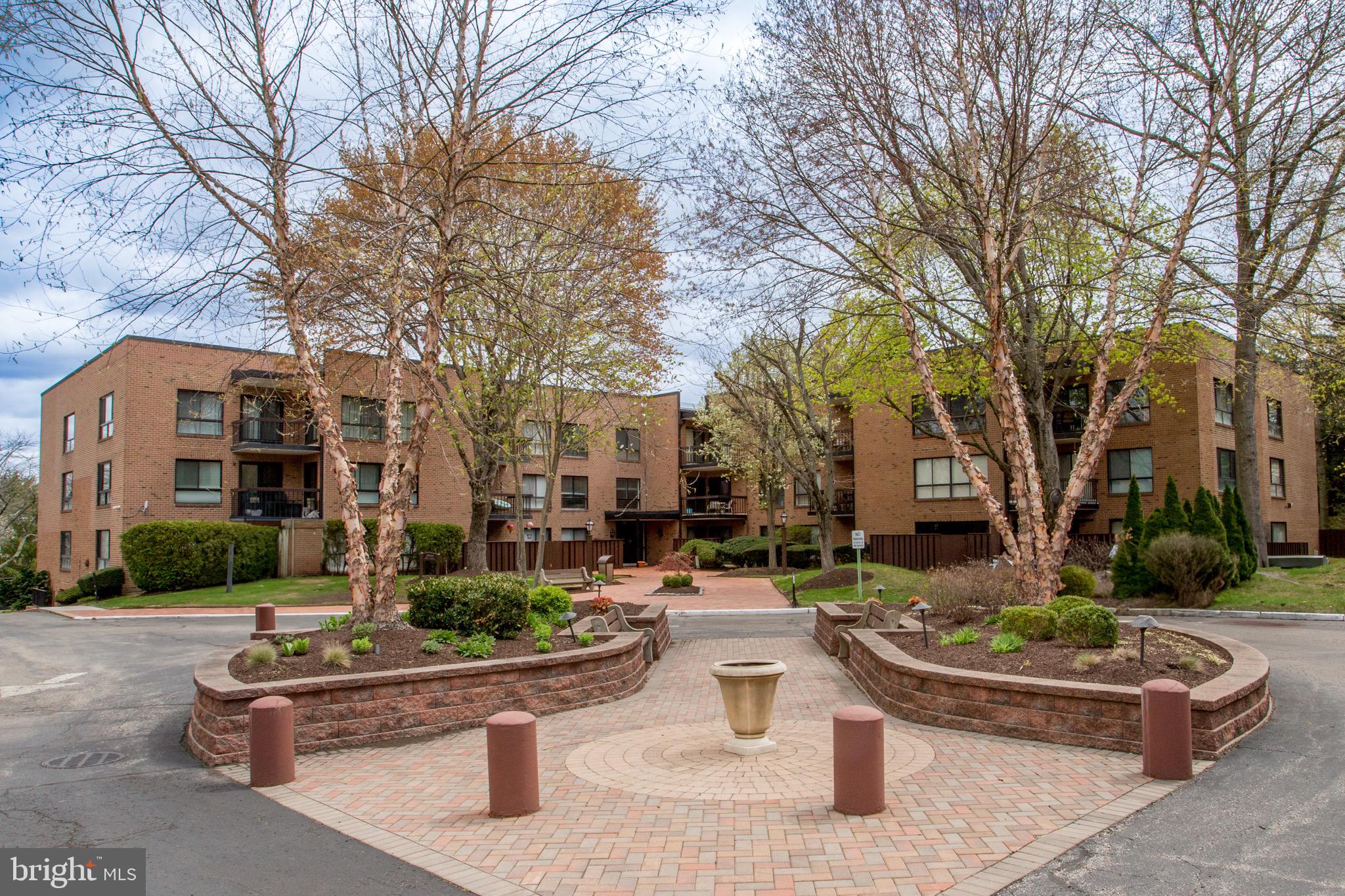 1680 Huntingdon Pike, Unit CONDO 224 Huntingdon Valley, PA 19006 - Photo 2 of 50 a front view of a house with a garden and tree