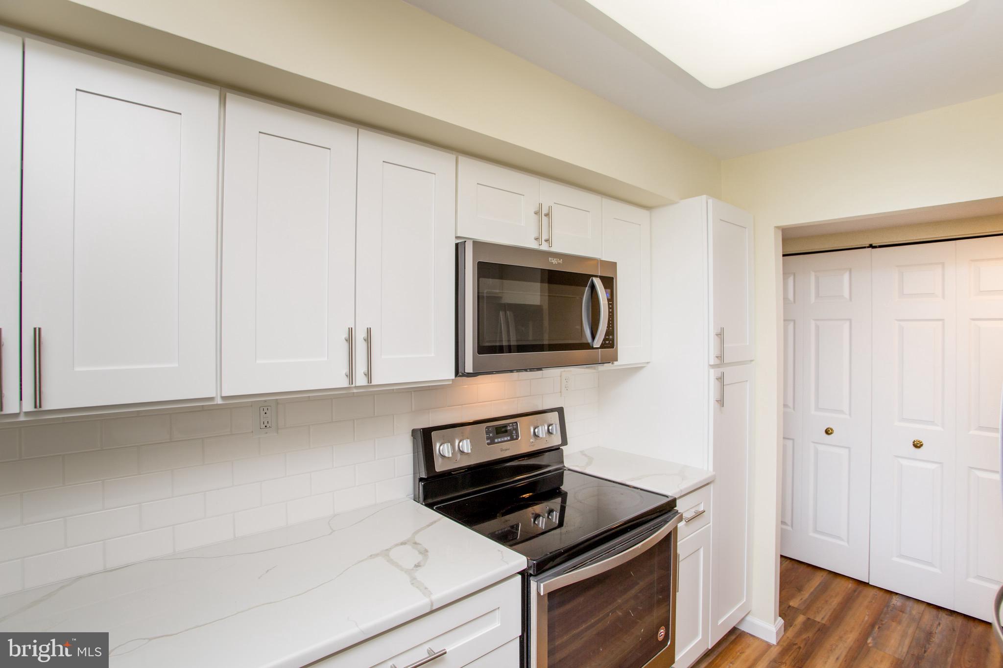 1680 Huntingdon Pike, Unit CONDO 224 Huntingdon Valley, PA 19006 - Photo 25 of 50 a kitchen with white cabinets and stainless steel appliances