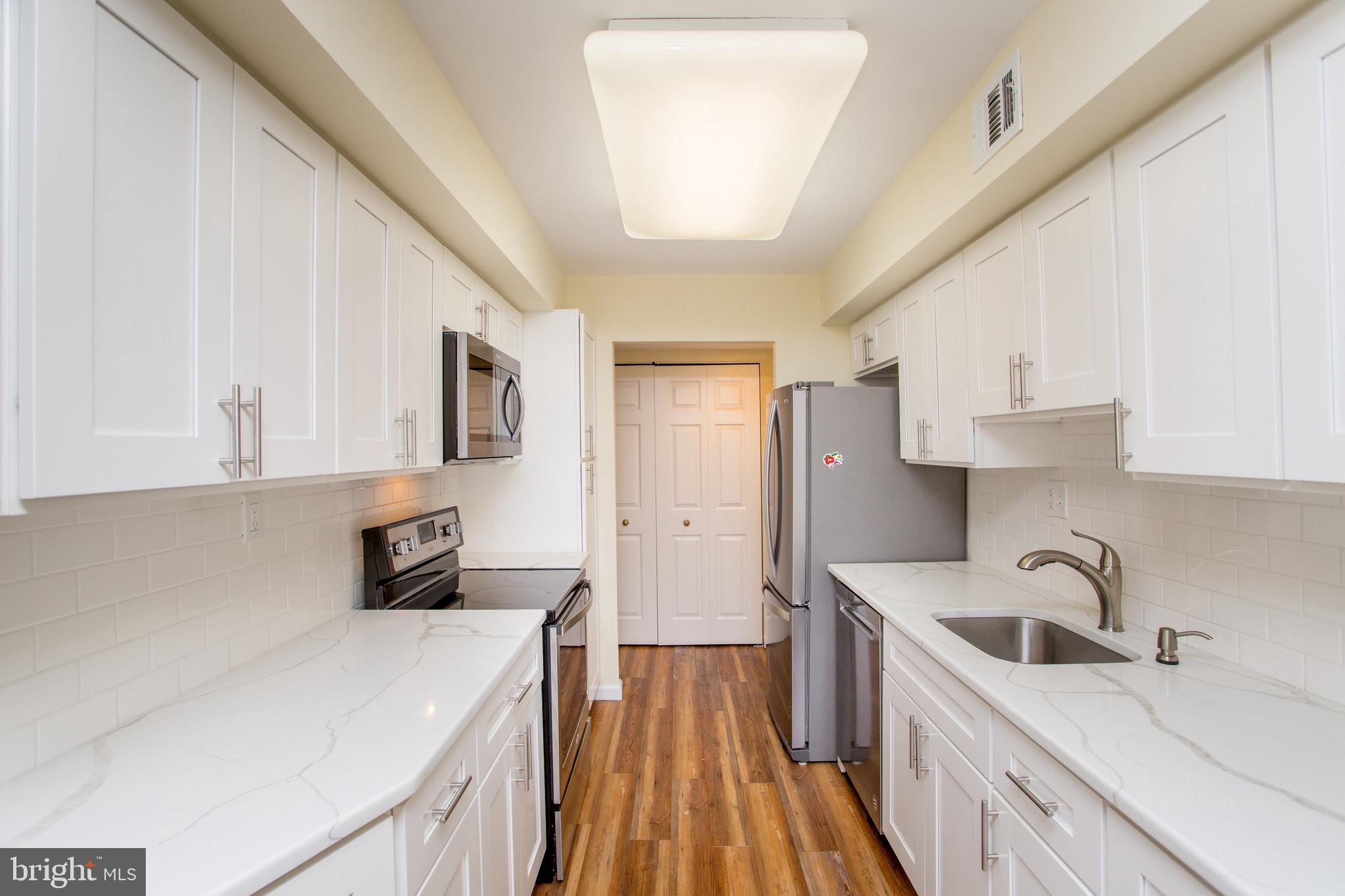 1680 Huntingdon Pike, Unit CONDO 224 Huntingdon Valley, PA 19006 - Photo 26 of 50 a kitchen with stainless steel appliances a sink a stove a refrigerator cabinets and a window
